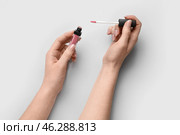 Woman with lipgloss on light background. Стоковое фото, фотограф Pixel_shot / Фотобанк Лори