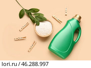 Laundry detergents, clothespins and plant branch on beige background. Стоковое фото, фотограф Pixel_shot / Фотобанк Лори