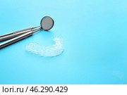 Dental instruments and occlusal splint on color background. Стоковое фото, фотограф Pixel_shot / Фотобанк Лори