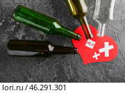 Empty bottles with paper heart on grunge background. Concept of alcoholism. Стоковое фото, фотограф Pixel_shot / Фотобанк Лори