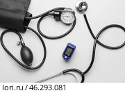Pulse oximeter with sphygmomanometer and stethoscope on light background. Стоковое фото, фотограф Pixel_shot / Фотобанк Лори