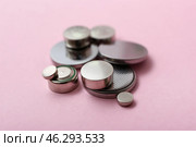 Lithium button cell batteries on pink background. Стоковое фото, фотограф Pixel_shot / Фотобанк Лори