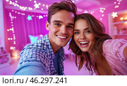 A happy young couple takes a selfie against the backdrop of bright garlands and sparkling snowflakes, conveying an atmosphere of joy, coziness and festive mood. Стоковое AI-изображение, AI-художник ArtVladZ / Фотобанк Лори