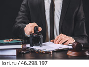Notary public with stamp working in office, closeup. Стоковое фото, фотограф Pixel_shot / Фотобанк Лори