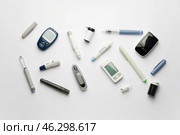 Glucometers with lancet pens and syringe on white background. Стоковое фото, фотограф Pixel_shot / Фотобанк Лори