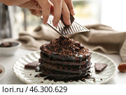 Woman grating chocolate over tasty pancakes, closeup. Стоковое фото, фотограф Pixel_shot / Фотобанк Лори