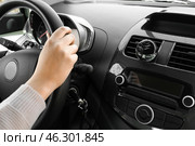 Young woman holding hands on steering wheel and air freshener hanging in car, closeup. Стоковое фото, фотограф Pixel_shot / Фотобанк Лори
