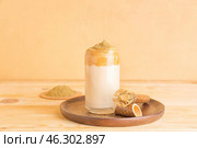 Glass of tasty dalgona hojicha latte and chasen on table. Стоковое фото, фотограф Pixel_shot / Фотобанк Лори