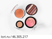 Eyeshadows, blush and makeup powder on light background. Стоковое фото, фотограф Pixel_shot / Фотобанк Лори