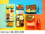 Different tasty food in lunchboxes and sticky notes with text LUNCH TIME on color background. Стоковое фото, фотограф Pixel_shot / Фотобанк Лори