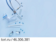 Stethoscope with gynecological speculum, pap smear test tools and pills on blue background. Стоковое фото, фотограф Pixel_shot / Фотобанк Лори