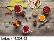 Flat lay composition with tasty cranberry sauce and ingredients on wooden background. Стоковое фото, фотограф Pixel_shot / Фотобанк Лори