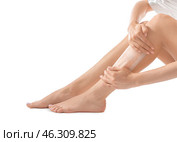 Young woman epilating her legs with wax on white background. Стоковое фото, фотограф Pixel_shot / Фотобанк Лори
