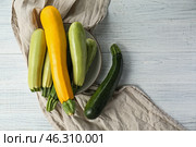Plate with fresh zucchinis on white wooden table. Стоковое фото, фотограф Pixel_shot / Фотобанк Лори