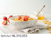 Bowl with healthy cornflakes and strawberry on white table. Стоковое фото, фотограф Pixel_shot / Фотобанк Лори