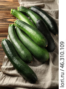 Ripe zucchinis on wooden table. Стоковое фото, фотограф Pixel_shot / Фотобанк Лори