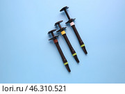 Syringe of esthetic filling material on color background. Стоковое фото, фотограф Pixel_shot / Фотобанк Лори