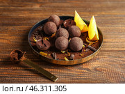 Plate with sweet truffles on wooden table. Стоковое фото, фотограф Pixel_shot / Фотобанк Лори
