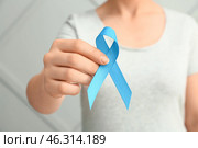 Woman with blue ribbon on grey background, closeup. Prostate cancer awareness concept. Стоковое фото, фотограф Pixel_shot / Фотобанк Лори