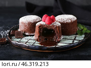 Plate with tasty lava cake fondant and raspberry on dark background, closeup. Стоковое фото, фотограф Pixel_shot / Фотобанк Лори