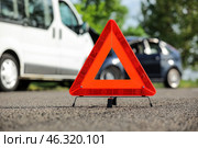 Emergency triangle stop sign near broken cars on road. Стоковое фото, фотограф Pixel_shot / Фотобанк Лори