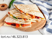 Board with tasty vegetarian quesadillas on white background. Стоковое фото, фотограф Pixel_shot / Фотобанк Лори