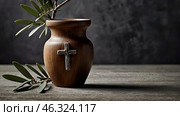 Religion, faith, liturgy, Ash Wednesday. Great lent. A wooden cross, a ceremonial bowl made of ash and an olive branch on a gray background. Стоковое AI-изображение, AI-художник Photojuli / Фотобанк Лори