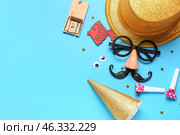 Funny glasses with paper fish, mousetrap and party decor on blue background. April Fools Day. Стоковое фото, фотограф Pixel_shot / Фотобанк Лори