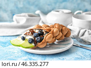 Plate with delicious sweet bubble waffle on table. Стоковое фото, фотограф Pixel_shot / Фотобанк Лори