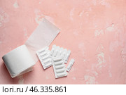 Toilet paper and hemorrhoidal suppositories on color background. Стоковое фото, фотограф Pixel_shot / Фотобанк Лори