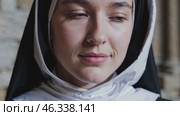 Serene nun expressing different emotions with her gaze. Стоковое видео, видеограф Данил Руденко / Фотобанк Лори