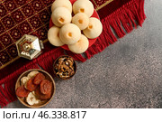 Tasty Eastern sweets with fanoos lamp and carpet on dark background. Стоковое фото, фотограф Pixel_shot / Фотобанк Лори
