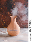 Aroma oil diffuser on table. Стоковое фото, фотограф Pixel_shot / Фотобанк Лори