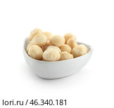 Bowl with peeled macadamia nuts on white background. Стоковое фото, фотограф Pixel_shot / Фотобанк Лори