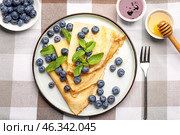 Plate with tasty blini and blueberry on table. Стоковое фото, фотограф Pixel_shot / Фотобанк Лори