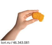 Female hand with tasty nugget on white background. Стоковое фото, фотограф Pixel_shot / Фотобанк Лори
