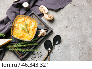 Baking dish with tasty julienne and ingredients on grey background. Стоковое фото, фотограф Pixel_shot / Фотобанк Лори