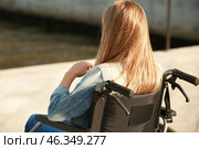 Teenage girl in wheelchair near river. Стоковое фото, фотограф Pixel_shot / Фотобанк Лори