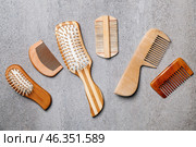 Many different combs and hairbrushes on grey background, flat lay. Стоковое фото, фотограф Pixel_shot / Фотобанк Лори
