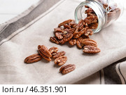Overturned jar with pecan nuts on table. Стоковое фото, фотограф Pixel_shot / Фотобанк Лори