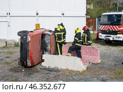 Firefighters intervening on overturned car after road accident. Стоковое фото, фотограф Константин Шишкин / Фотобанк Лори