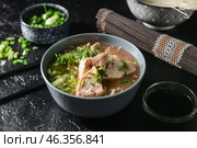 Tasty Chinese soup with chicken in bowl on dark background. Стоковое фото, фотограф Pixel_shot / Фотобанк Лори
