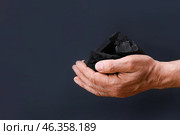 Male hands and charcoal on dark background. Стоковое фото, фотограф Pixel_shot / Фотобанк Лори