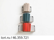Creative composition with books on shelves on light wall. Стоковое фото, фотограф Pixel_shot / Фотобанк Лори