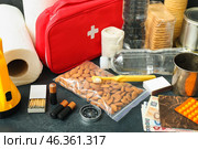 Necessities for emergency bag on dark table, closeup. Стоковое фото, фотограф Pixel_shot / Фотобанк Лори