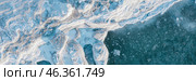 Winter aerial photograph of the icy coast and ice floes in sea water. Top view of the freezing sea. Northern nature. Frosty winter weather. Cold arctic climate. Beautiful wide panoramic background. Стоковое фото, фотограф Андрей Степанов / Фотобанк Лори