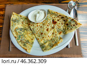 Delicious gourmet flat bread kutabs with herbs and cheese on a plate. Стоковое фото, фотограф Евгений Ткачёв / Фотобанк Лори