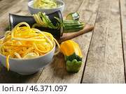 Fresh zucchini spaghetti with spiral grater on wooden table. Стоковое фото, фотограф Pixel_shot / Фотобанк Лори