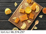 Jar with sweet honey and pieces of fresh combs on wooden board. Стоковое фото, фотограф Pixel_shot / Фотобанк Лори