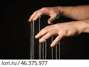 Hands of puppeteer on dark background. Стоковое фото, фотограф Pixel_shot / Фотобанк Лори